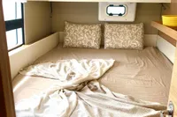 Cozy bedroom in 2022 Nautitech 40 Open catamaran with elegant bedding and soft lighting.