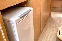 Interior of 2022 Nautitech 40 Open yacht with compact fridge and wooden finish.