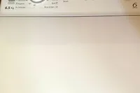A Whirlpool washing machine control panel with various settings and a digital display.
