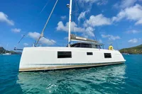 2022 Nautitech 40 Open catamaran sailing on clear blue waters under a sunny sky.