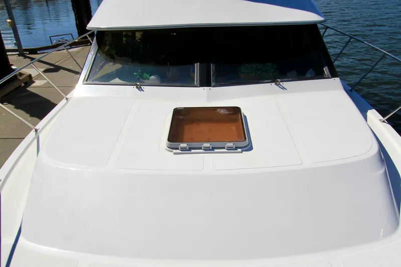 Sea Mistress Yacht Photos Pics 1987 Ocean Alexander 42 yacht deck with hatch, docked by the water.