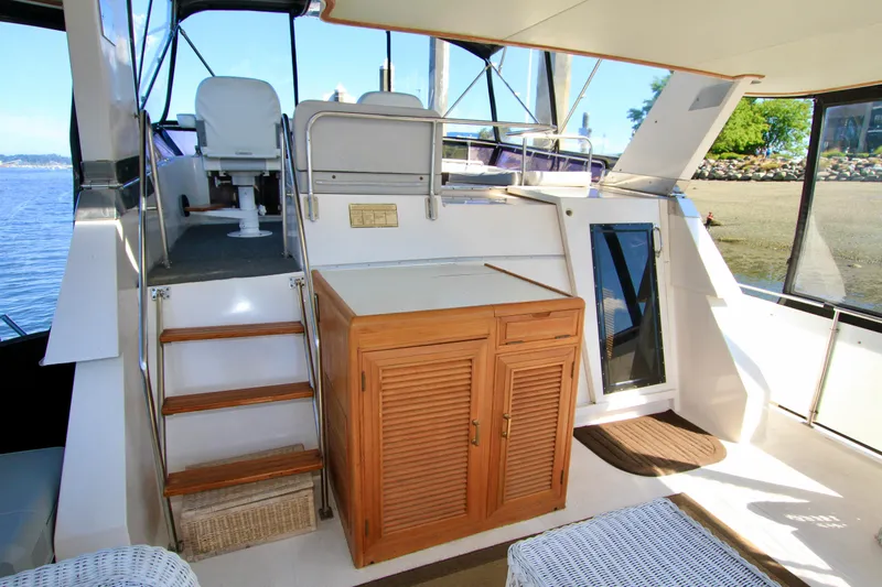 Sea Mistress Yacht Photos Pics 1987 Ocean Alexander 42 yacht interior with wooden cabinetry and seating area.
