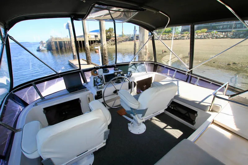 Sea Mistress Yacht Photos Pics Interior view of 1987 Ocean Alexander 42 yacht cockpit with dual white captain chairs.