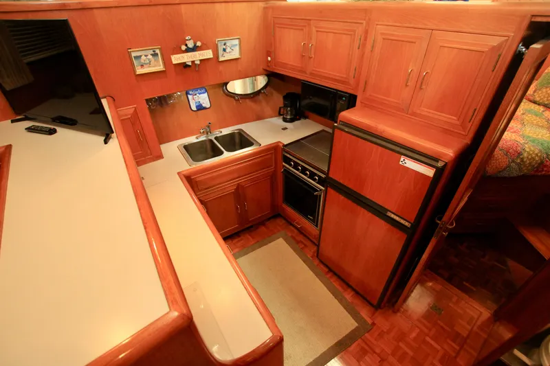 Sea Mistress Yacht Photos Pics 1987 Ocean Alexander 42 yacht kitchen with wood cabinetry, double sink, and appliances.