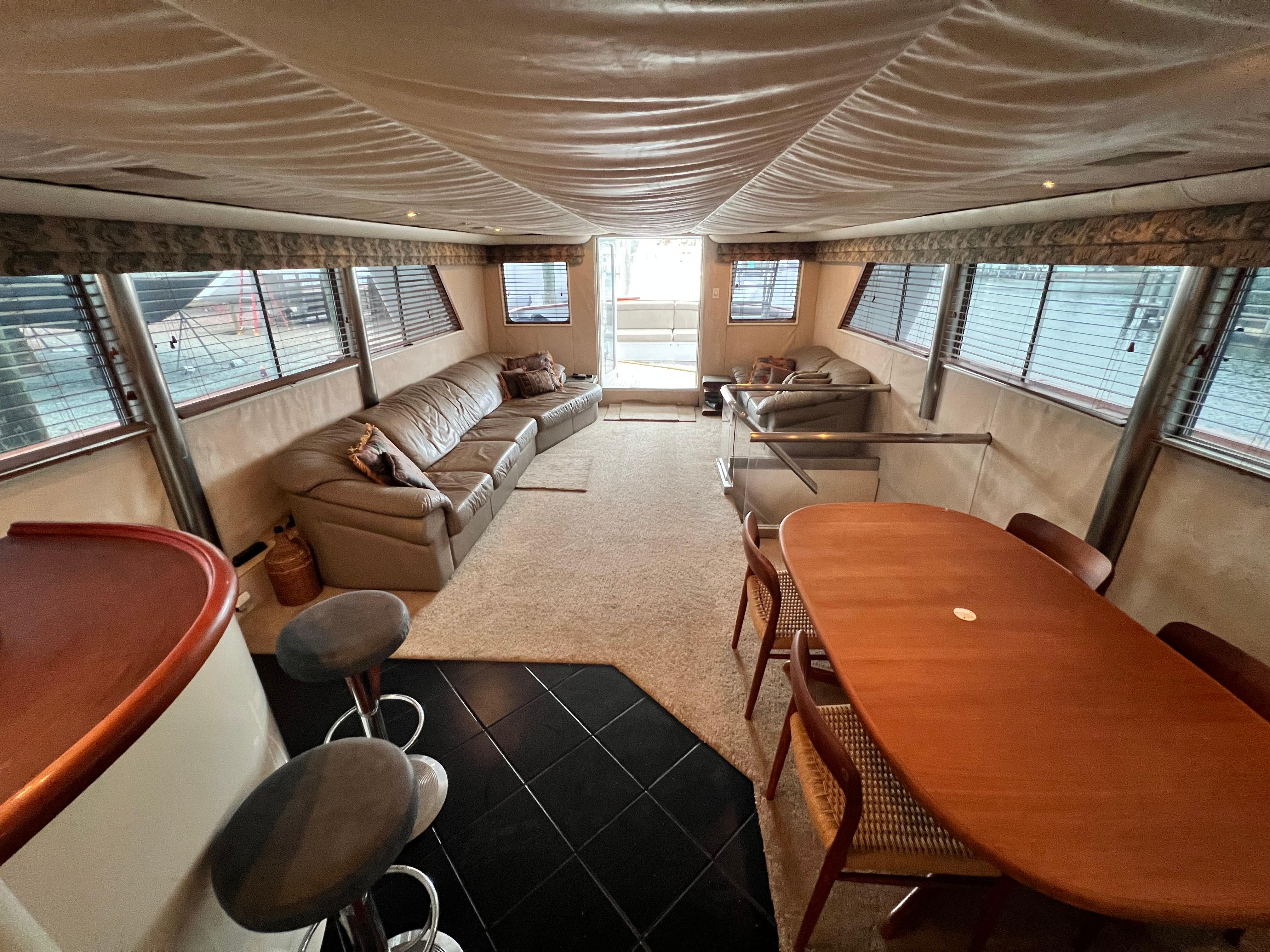 Luxurious interior of 1988 Custom Steel Motor Yacht with seating and dining area.