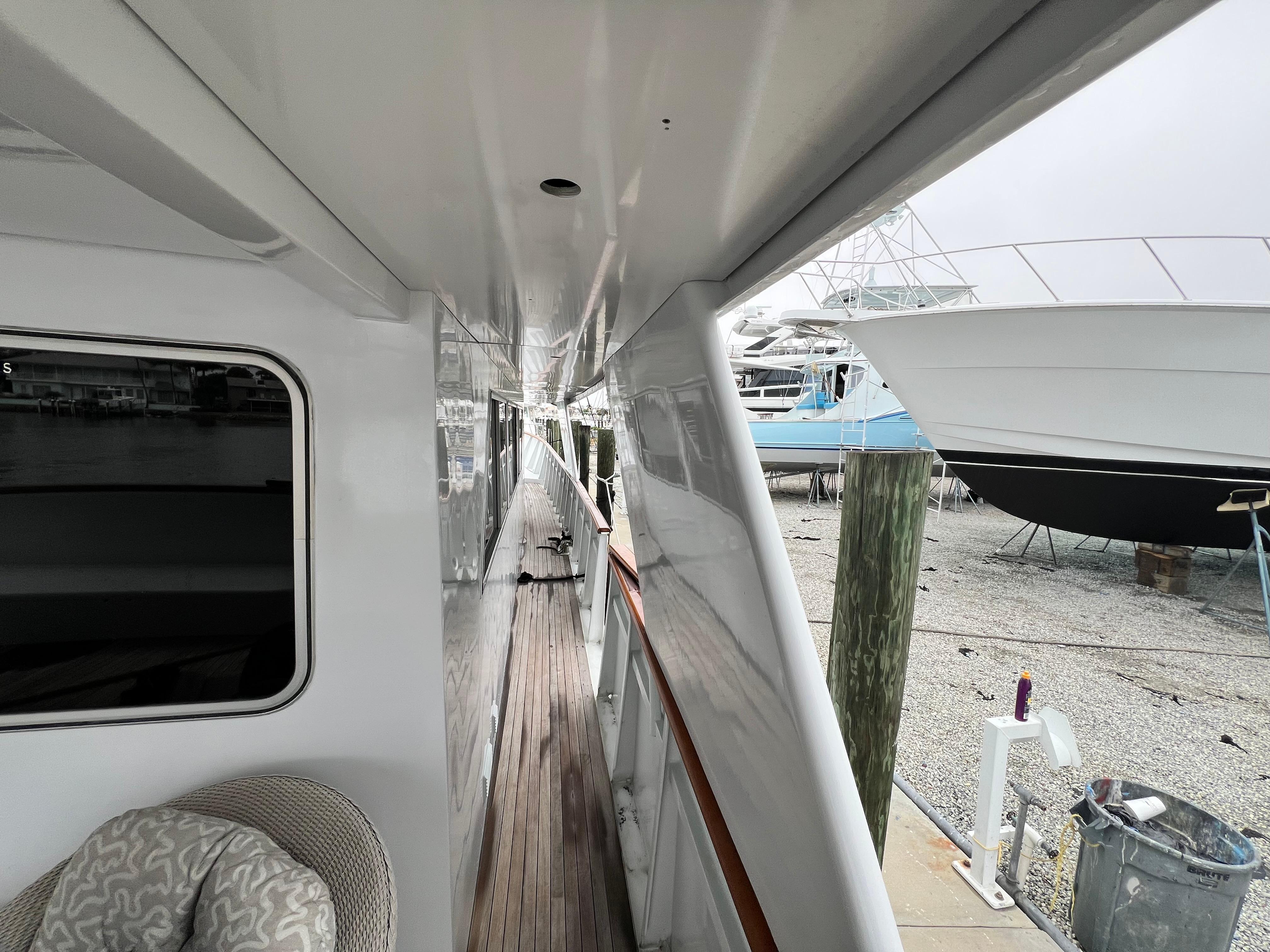 Side deck of a 1988 Custom Steel Motor Yacht in a marina setting.