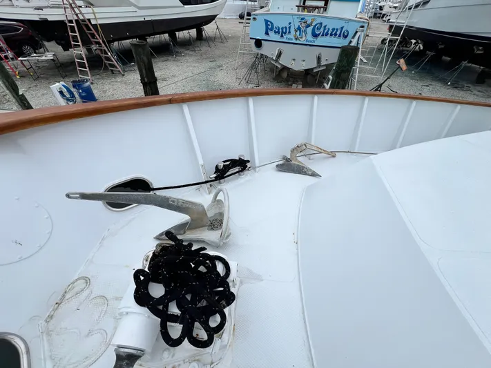 Ain't No Big Thing Yacht Photos Pics Custom 1988 steel motor yacht deck with anchor and rope, docked near "Papi Chulo" boat.