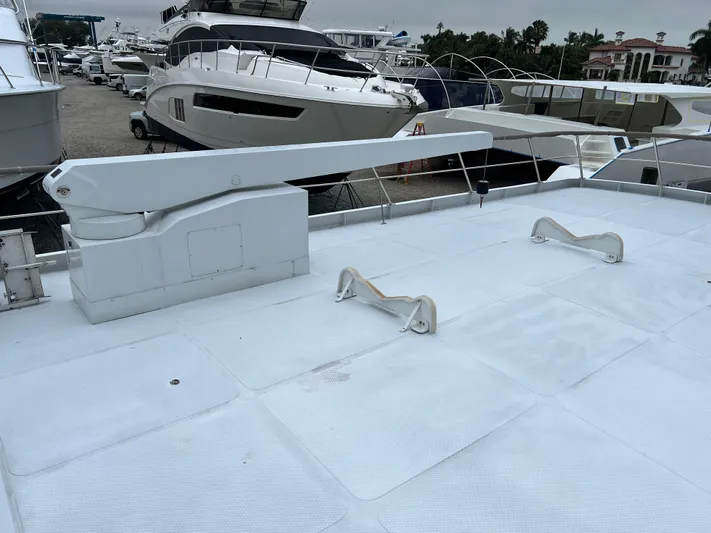 Ain't No Big Thing Yacht Photos Pics Custom 1988 steel motor yacht deck with davit, surrounded by other luxury boats.