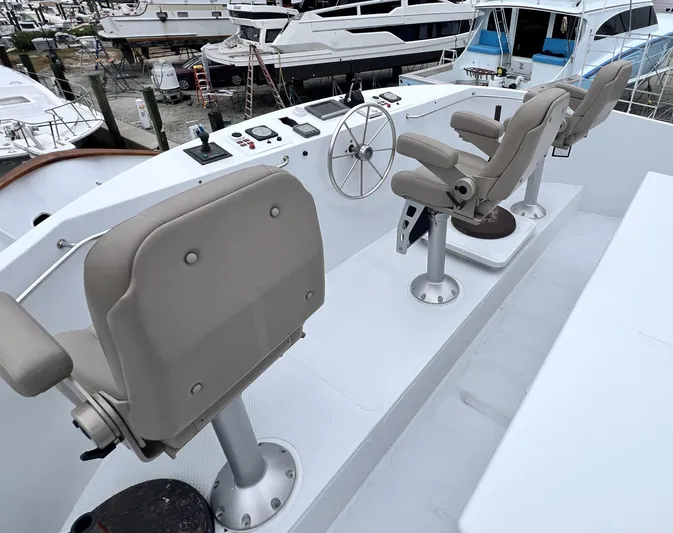 Ain't No Big Thing Yacht Photos Pics Captain's chairs and helm on 1988 Custom Steel Motor Yacht deck.