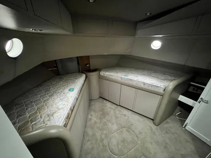 Ain't No Big Thing Yacht Photos Pics Interior of 1988 Custom Steel Motor Yacht with twin beds and porthole windows.