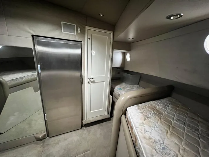 Ain't No Big Thing Yacht Photos Pics Interior of 1988 Custom Steel Motor Yacht with twin beds and sleek metallic finishes.