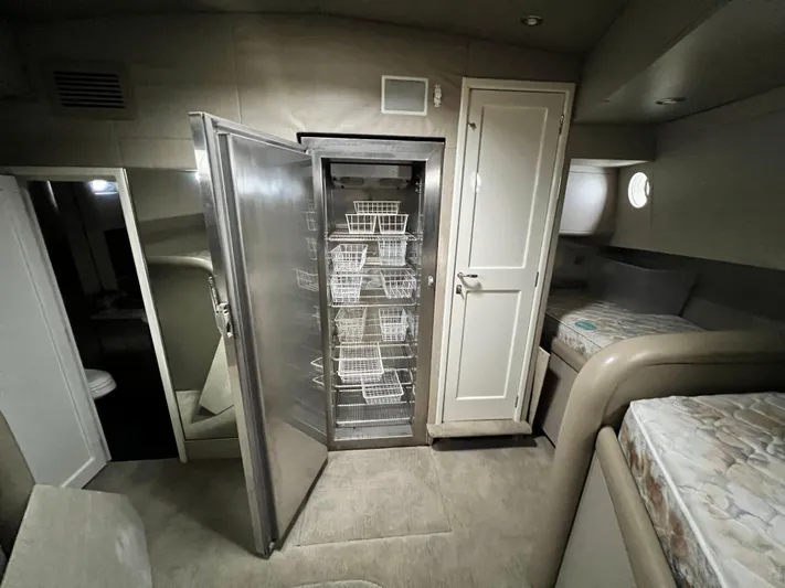 Ain't No Big Thing Yacht Photos Pics Interior of 1988 Custom Steel Motor Yacht with open stainless steel storage and bunk beds.