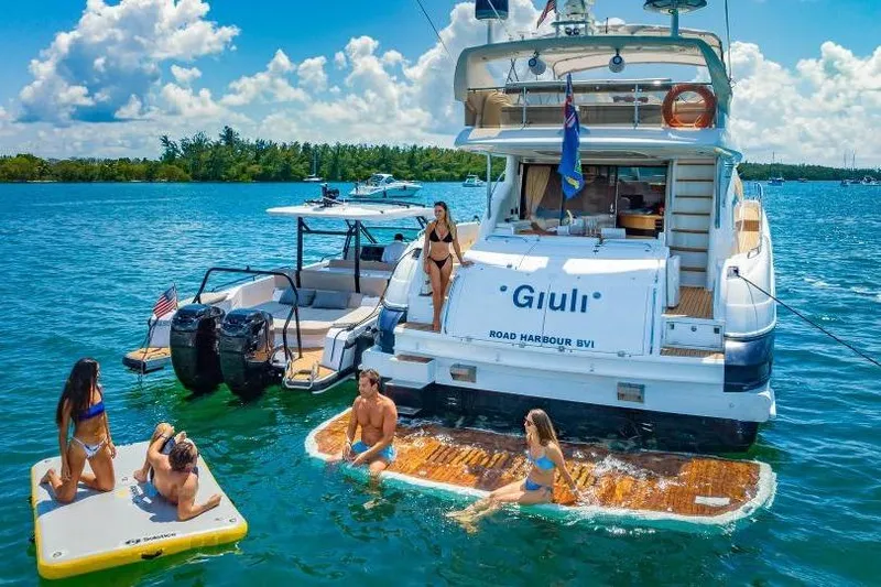  Yacht Photos Pics People enjoying water activities near a 2000 Sunseeker Manhattan 74 yacht.