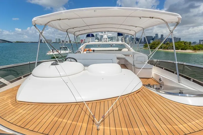  Yacht Photos Pics Sunseeker Manhattan 74 yacht, 2000 model, with spacious deck and canopy, cruising near city skyline.