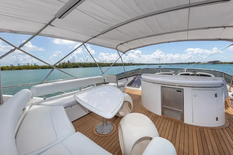  Yacht Photos Pics Luxurious Sunseeker Manhattan 74 yacht deck with seating, table, and ocean view, year 2000 model.