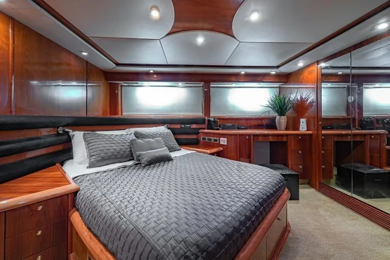  Yacht Photos Pics Luxurious bedroom interior of 2000 Sunseeker Manhattan 74 yacht with elegant wood finish.