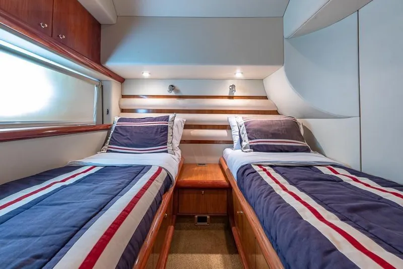  Yacht Photos Pics Twin cabin interior of 2000 Sunseeker Manhattan 74 yacht with striped bedding.