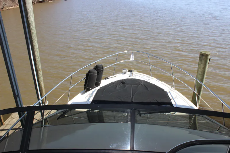  Yacht Photos Pics 2017 Sea Ray Fly 460 yacht docked, viewed from the helm, overlooking calm waters.