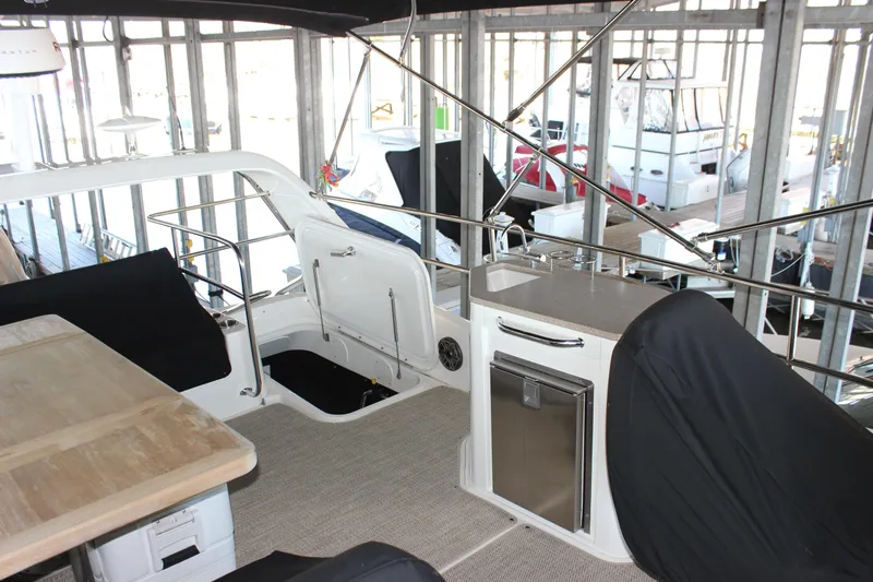  Yacht Photos Pics 2017 Sea Ray Fly 460 yacht interior with seating and kitchenette in a marina.