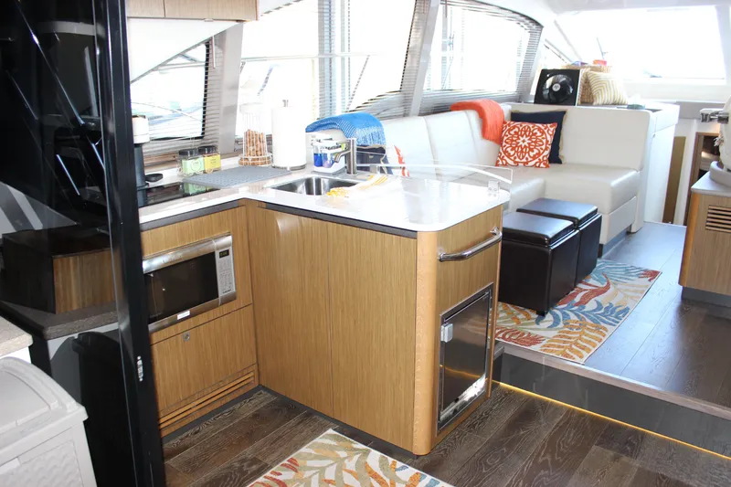  Yacht Photos Pics Interior of 2017 Sea Ray Fly 460 yacht with modern kitchen and cozy seating area.