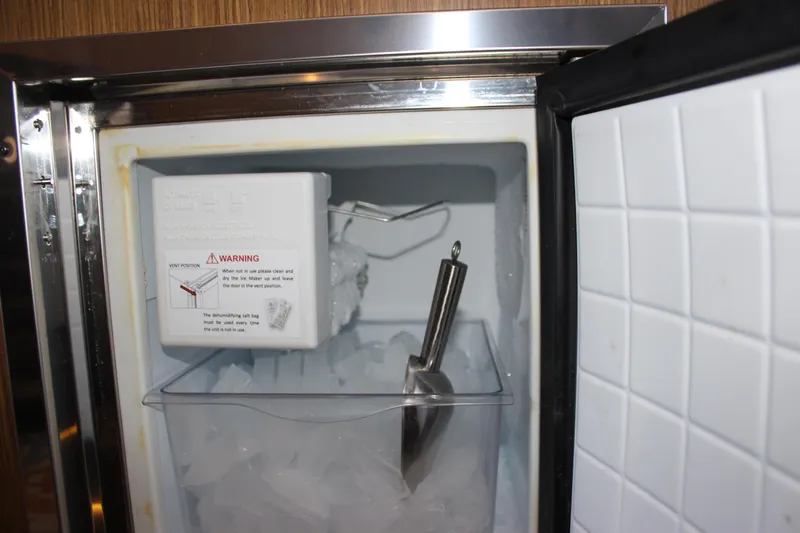  Yacht Photos Pics Ice maker inside 2017 Sea Ray Fly 460 yacht, featuring ice scoop and warning label.
