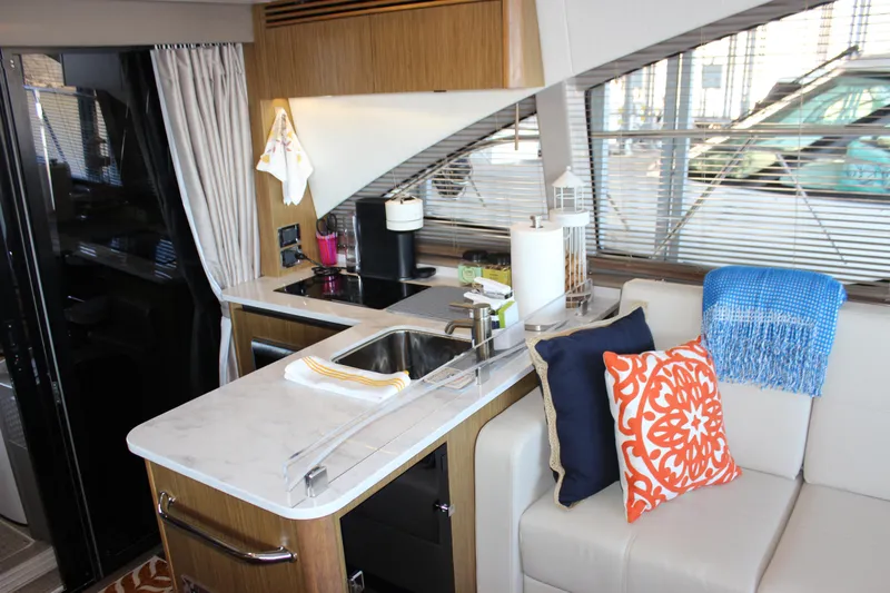  Yacht Photos Pics Interior of 2017 Sea Ray Fly 460 yacht with modern kitchen and cozy seating area.