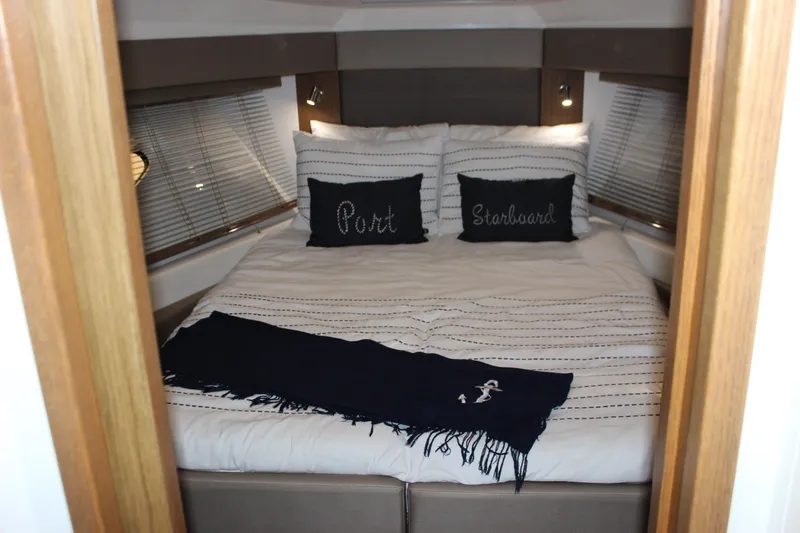  Yacht Photos Pics Luxurious bedroom interior of 2017 Sea Ray Fly 460 yacht with nautical-themed decor.