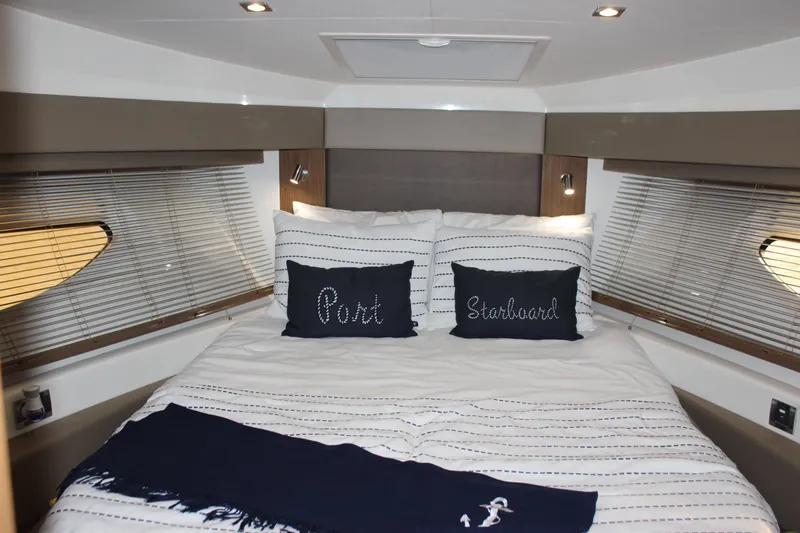  Yacht Photos Pics Luxurious bedroom interior of 2017 Sea Ray Fly 460 yacht with nautical-themed decor.