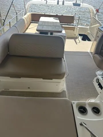  Yacht Photos Pics 2017 Sea Ray Fly 460 yacht interior with seating and table, overlooking water.