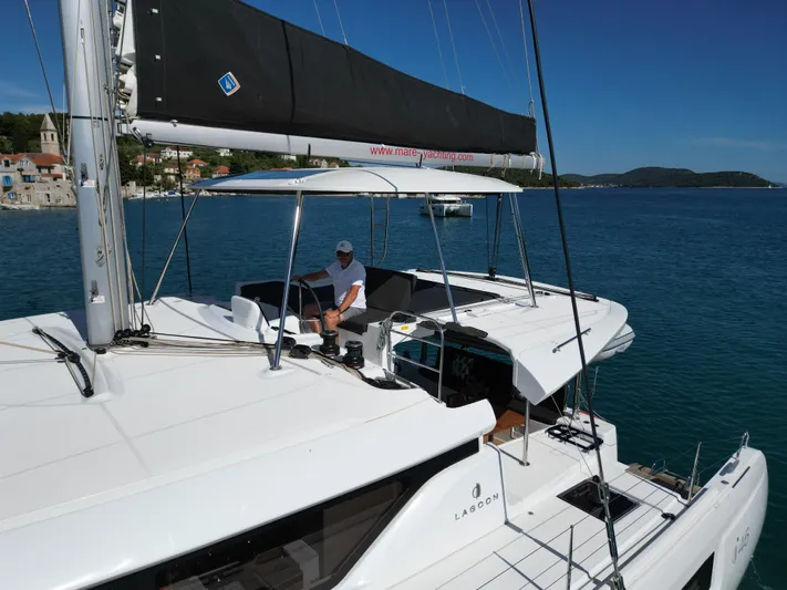 Mare Azul Yacht Photos Pics 2024 Lagoon 46 catamaran sailing in calm blue waters, featuring a spacious deck and modern design.