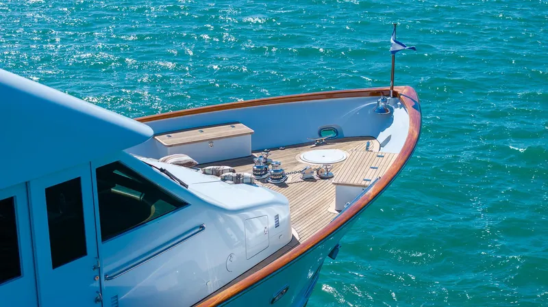  Yacht Photos Pics Luxury yacht Burger 85 Deck House, 1999 model, cruising on clear blue waters.