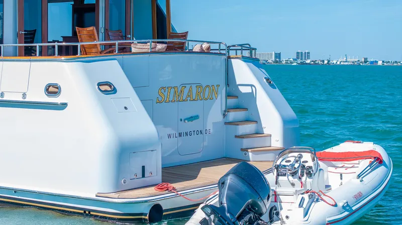  Yacht Photos Pics Luxury yacht "Simaron" with inflatable boat, Burger 85 Deck house, 1999, on clear blue water.