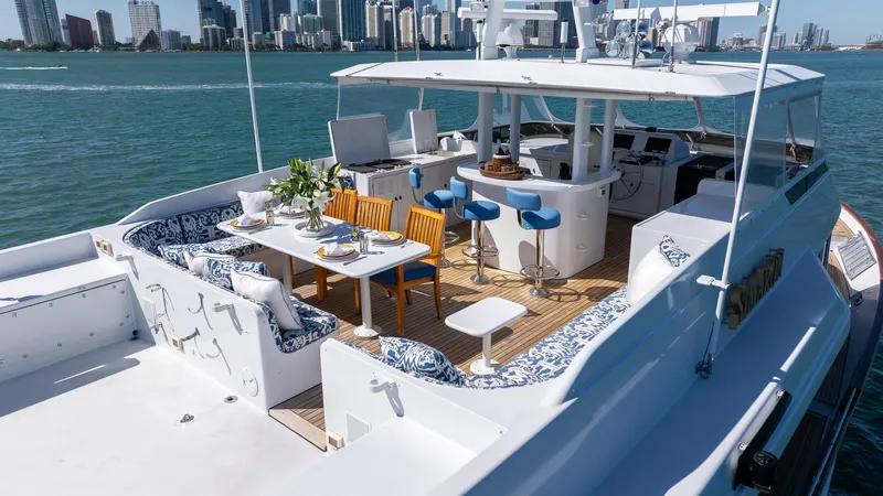  Yacht Photos Pics Luxurious 1999 Burger 85 Deck House yacht with elegant outdoor seating and dining area.