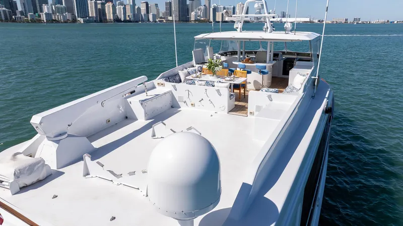  Yacht Photos Pics Luxury 1999 Burger 85 Deck House yacht cruising near city skyline.