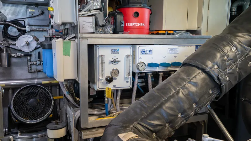  Yacht Photos Pics Engine room of 1999 Burger 85 Deck house yacht with machinery and tools.