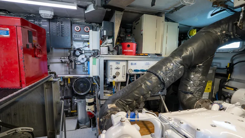  Yacht Photos Pics Engine room of a 1999 Burger 85 Deck house yacht, featuring machinery and equipment.