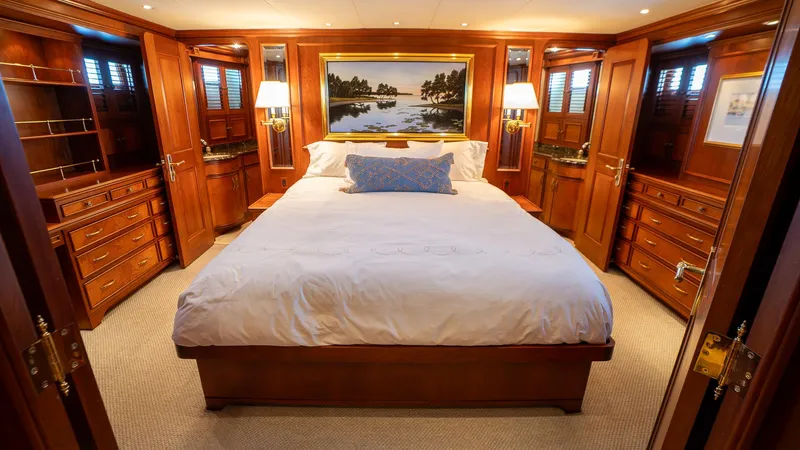  Yacht Photos Pics Luxurious bedroom in 1999 Burger 85 Deck house yacht with elegant wood paneling.