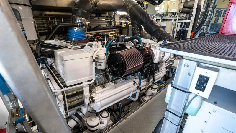  Yacht Photos Pics Engine room of 1999 Burger 85 Deck house yacht, showcasing complex machinery and components.