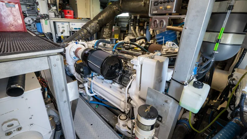 Yacht Photos Pics Engine room of a 1999 Burger 85 Deck house yacht, showcasing mechanical components and equipment.
