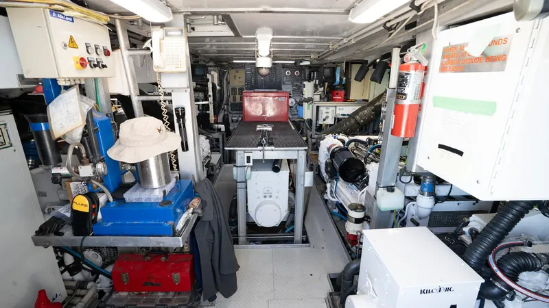  Yacht Photos Pics Engine room of 1999 Burger 85 Deck House yacht, featuring machinery and equipment.