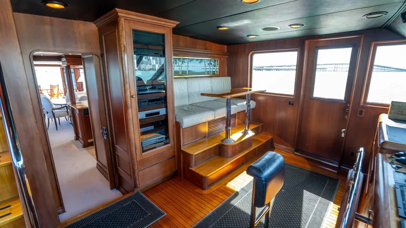  Yacht Photos Pics Luxurious interior of 1999 Burger 85 Deck house yacht with wooden finishes and seating area.