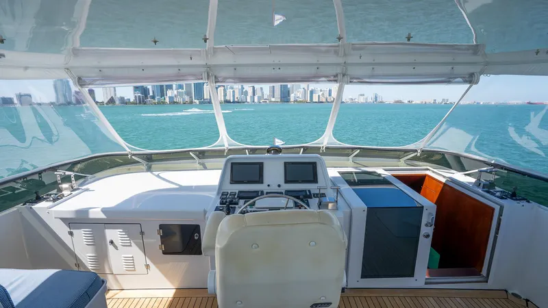  Yacht Photos Pics Interior view of 1999 Burger 85 Deck House yacht helm with city skyline.