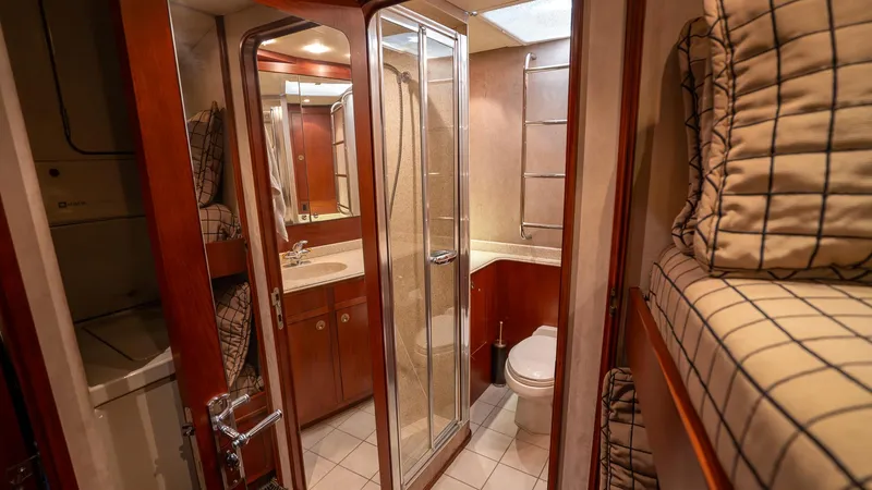  Yacht Photos Pics Bathroom interior of 1999 Burger 85 Deck House yacht with shower and bunk beds.