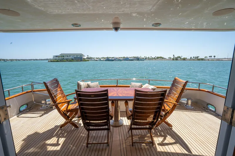  Yacht Photos Pics Deck view from 1999 Burger 85 Deck House yacht with chairs and table overlooking the water.