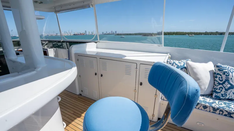  Yacht Photos Pics 1999 Burger 85 Deck House yacht interior with blue seating and ocean view.