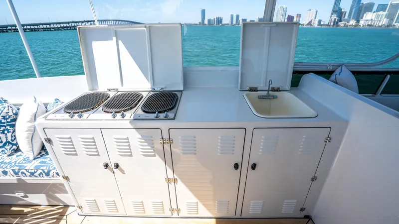  Yacht Photos Pics Outdoor kitchen on 1999 Burger 85 Deck house yacht with grill and sink, ocean view.