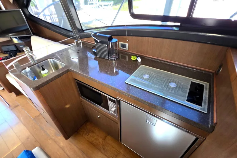  Yacht Photos Pics 2016 Sea Ray Sundancer 400 yacht kitchen with sink, stove, and appliances.