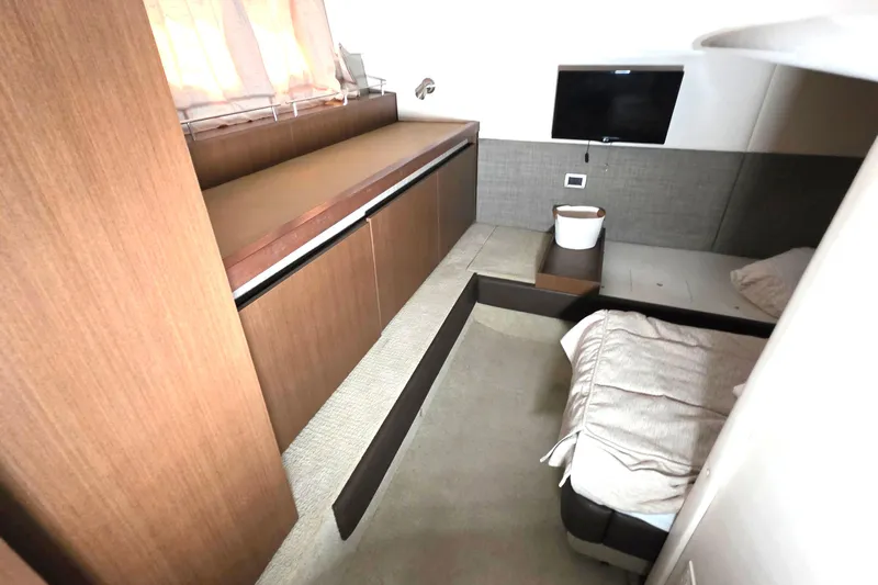  Yacht Photos Pics Interior cabin of 2016 Sea Ray Sundancer 400 yacht with bed, TV, and storage.