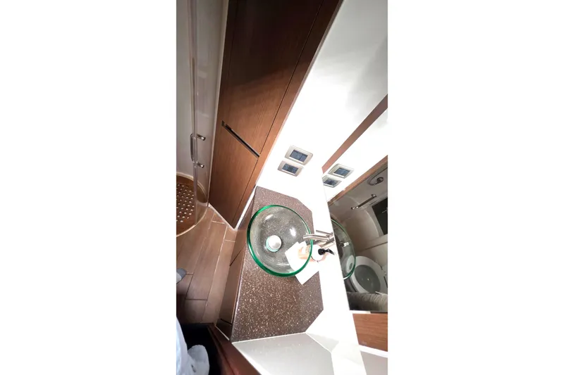  Yacht Photos Pics Luxurious bathroom interior of 2016 Sea Ray Sundancer 400 yacht with modern fixtures.