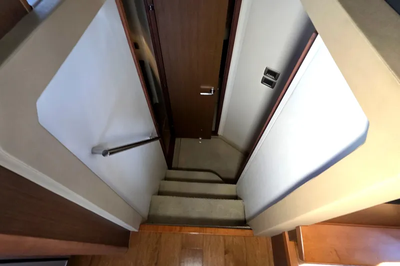  Yacht Photos Pics Staircase inside 2016 Sea Ray Sundancer 400 yacht, featuring wooden steps and modern design.